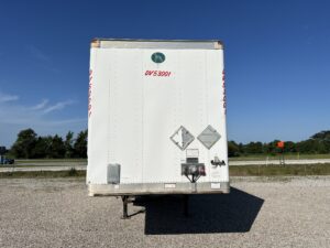 A white truck parked on the side of a road.