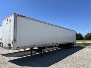 A large white semi truck parked on the side of a road.