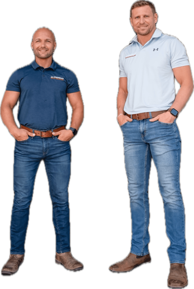 Two men standing next to each other wearing jeans.