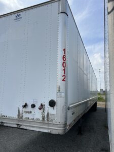 White cargo trailer with identification number 16012 on the side.