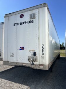 White KTR-WAY-LOG trailer parked outdoors under clear sky.