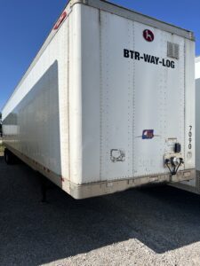 White trailer truck with black text BTR-WAY-LOGC on its side.