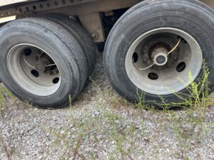 Two flat tires on the rear axle of a heavy vehicle.